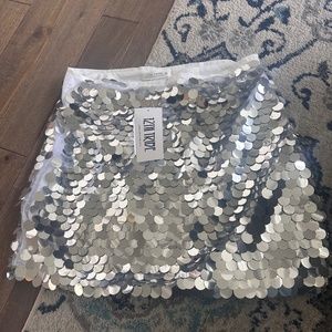 Silver skirt runs small size Medium